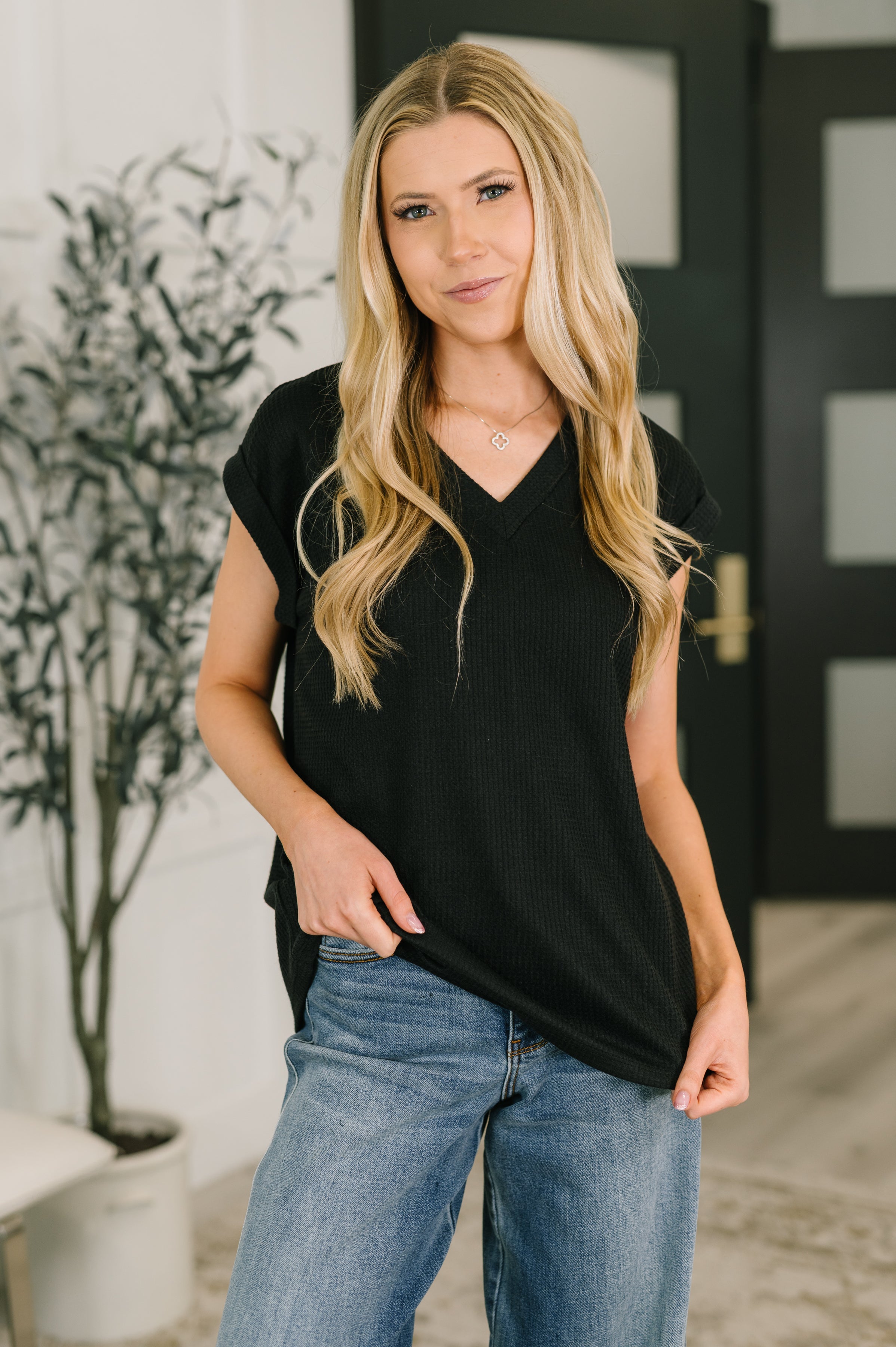 Black V-neck tee, waffle knit top, women's boxy tee, everyday essentials, stretch knit shirt, cuffed sleeve tee, casual chic fashion, timeless black top.