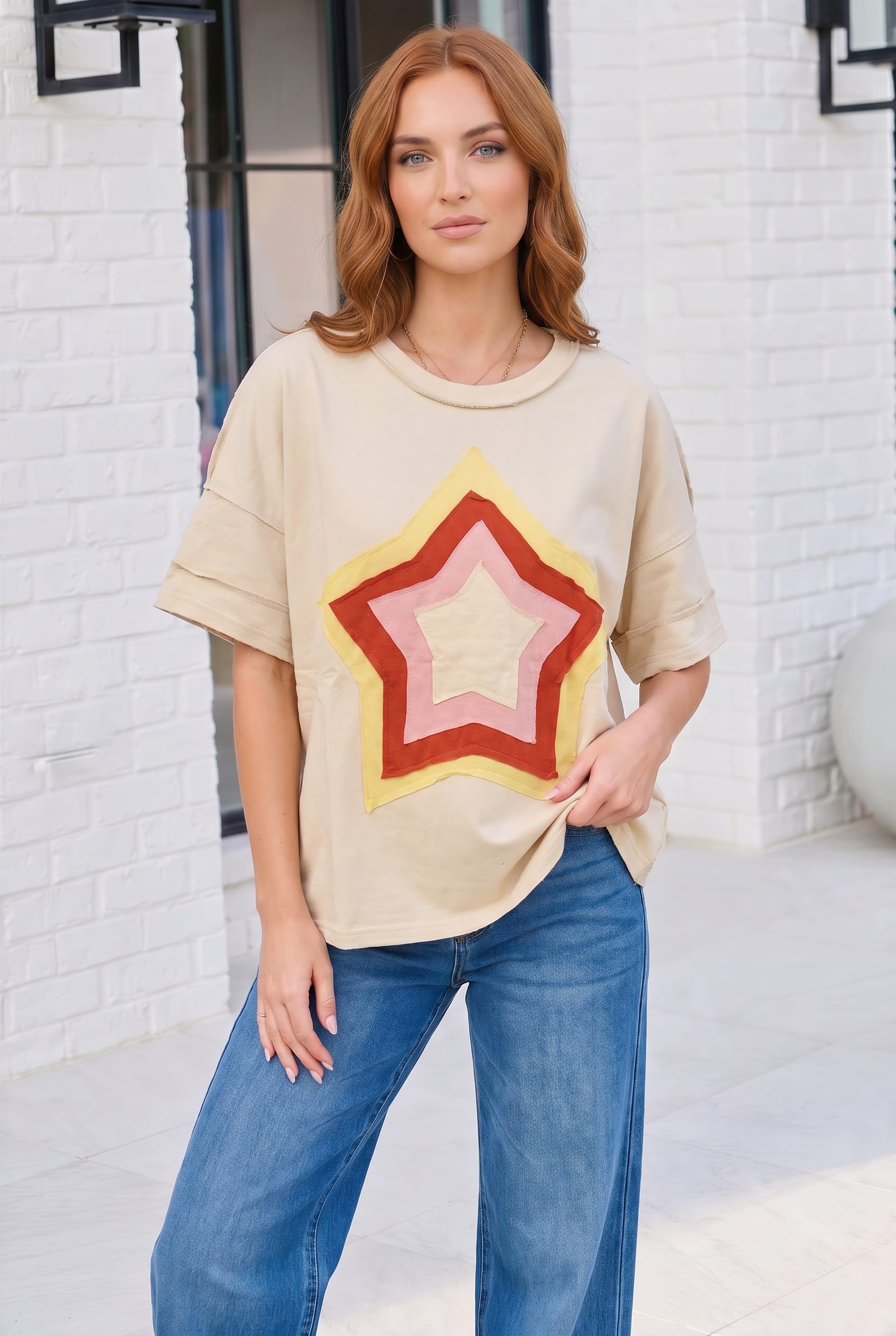 oversized graphic tee, retro star t-shirt, women's beige tee, relaxed fit top, cotton blend t-shirt, vintage style star shirt, streetwear aesthetic, casual brunch outfit, layered sleeve tee
