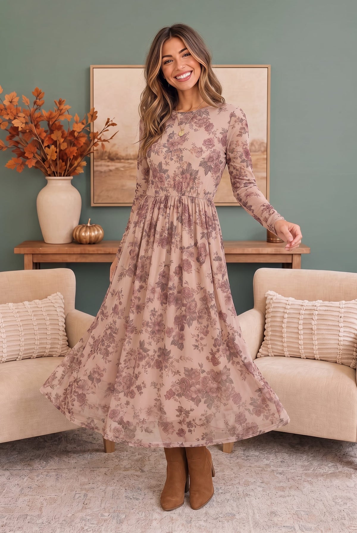 A woman wearing a blush midi dress with dusty rose floral print, long sleeves, and a flowing skirt.