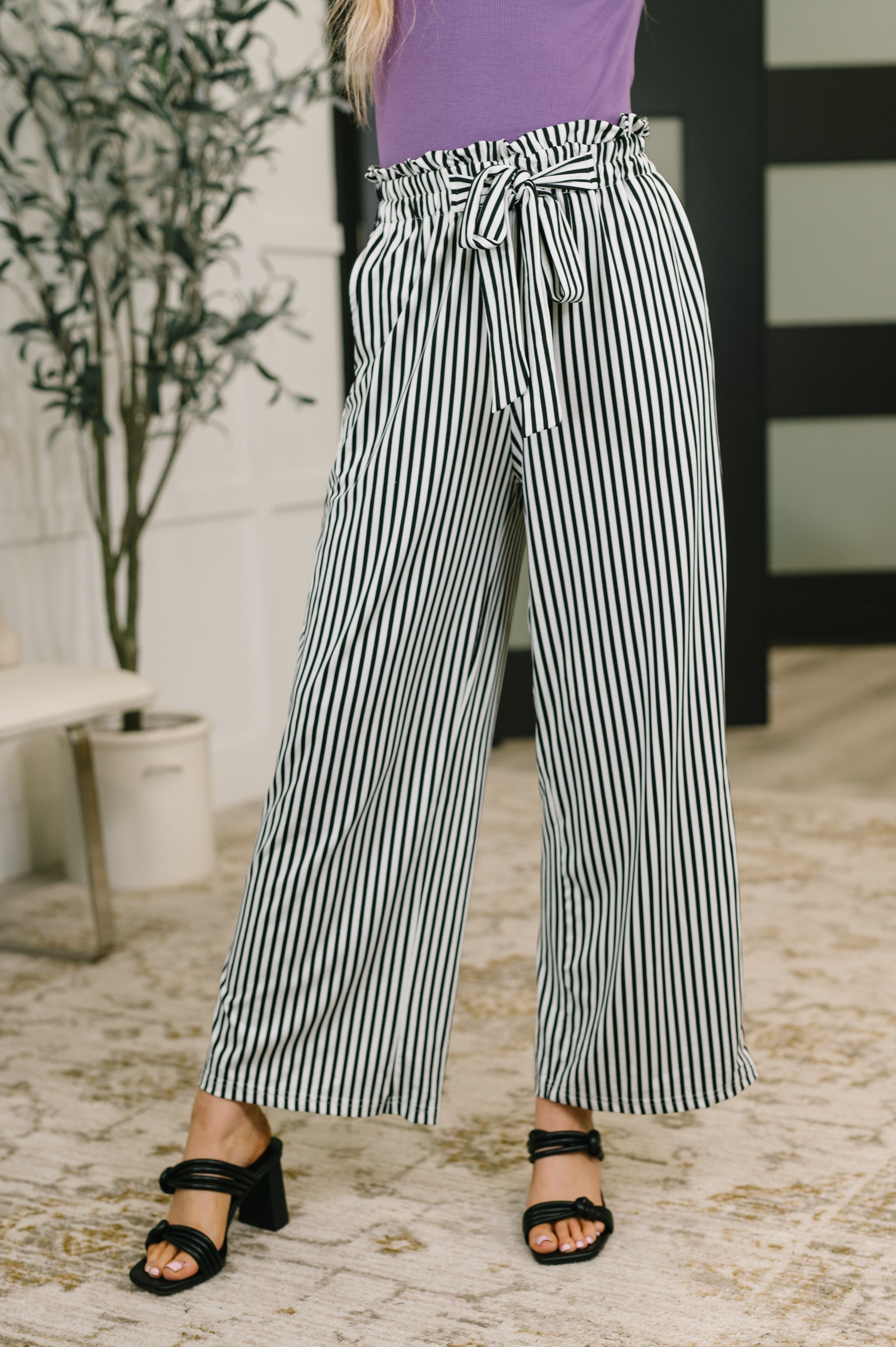 high waisted trousers, wide leg striped pants, jersey knit trousers, ruffle hem pants, comfortable work pants, women's elastic waist trousers, chic loungewear.