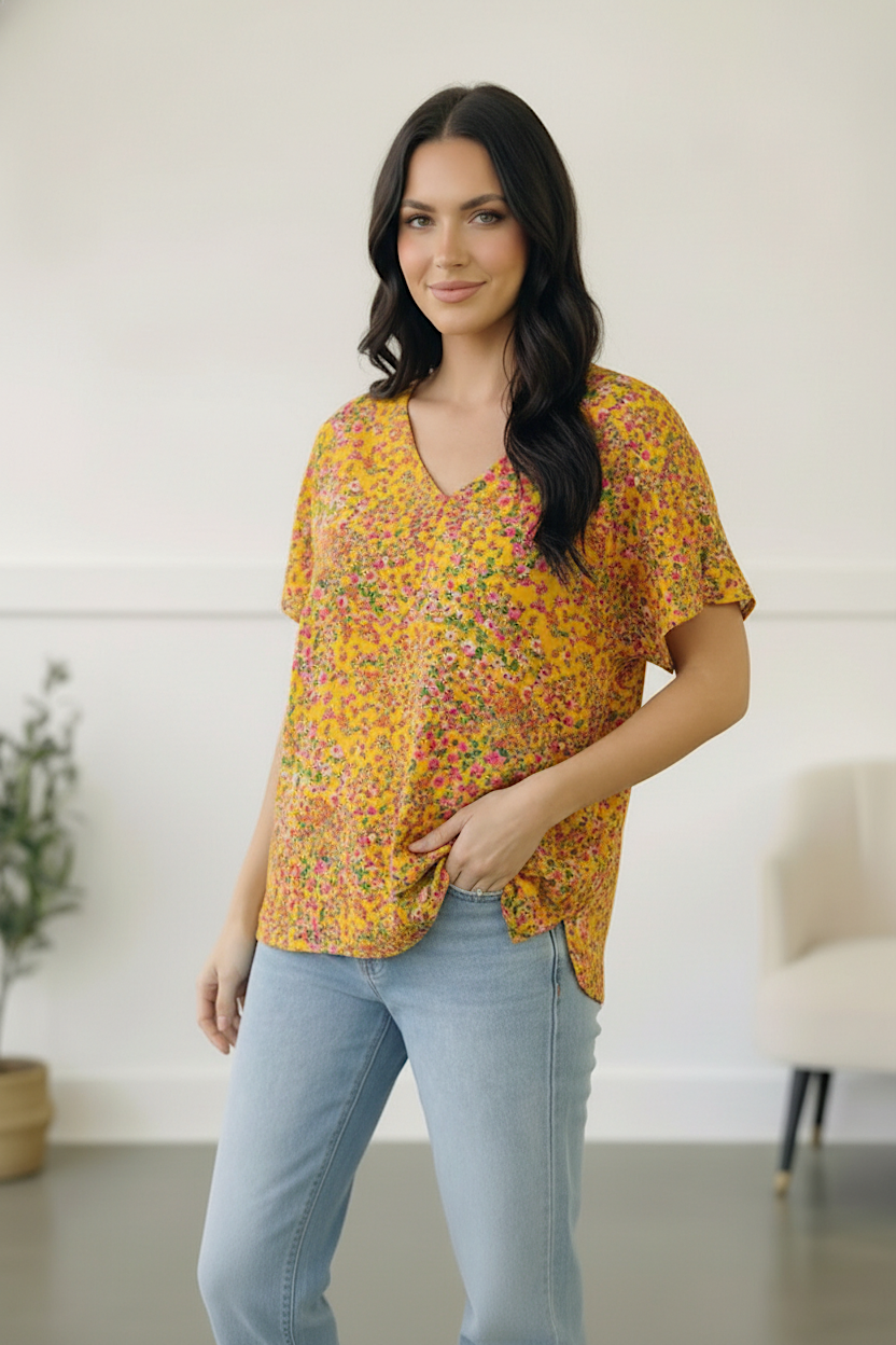 yellow floral top, women’s V-neck blouse, short sleeve floral shirt, ditsy floral top, summer boutique clothing, relaxed fit top, golden yellow blouse, lightweight spring top, 100% polyester top, yellow summer fashion.