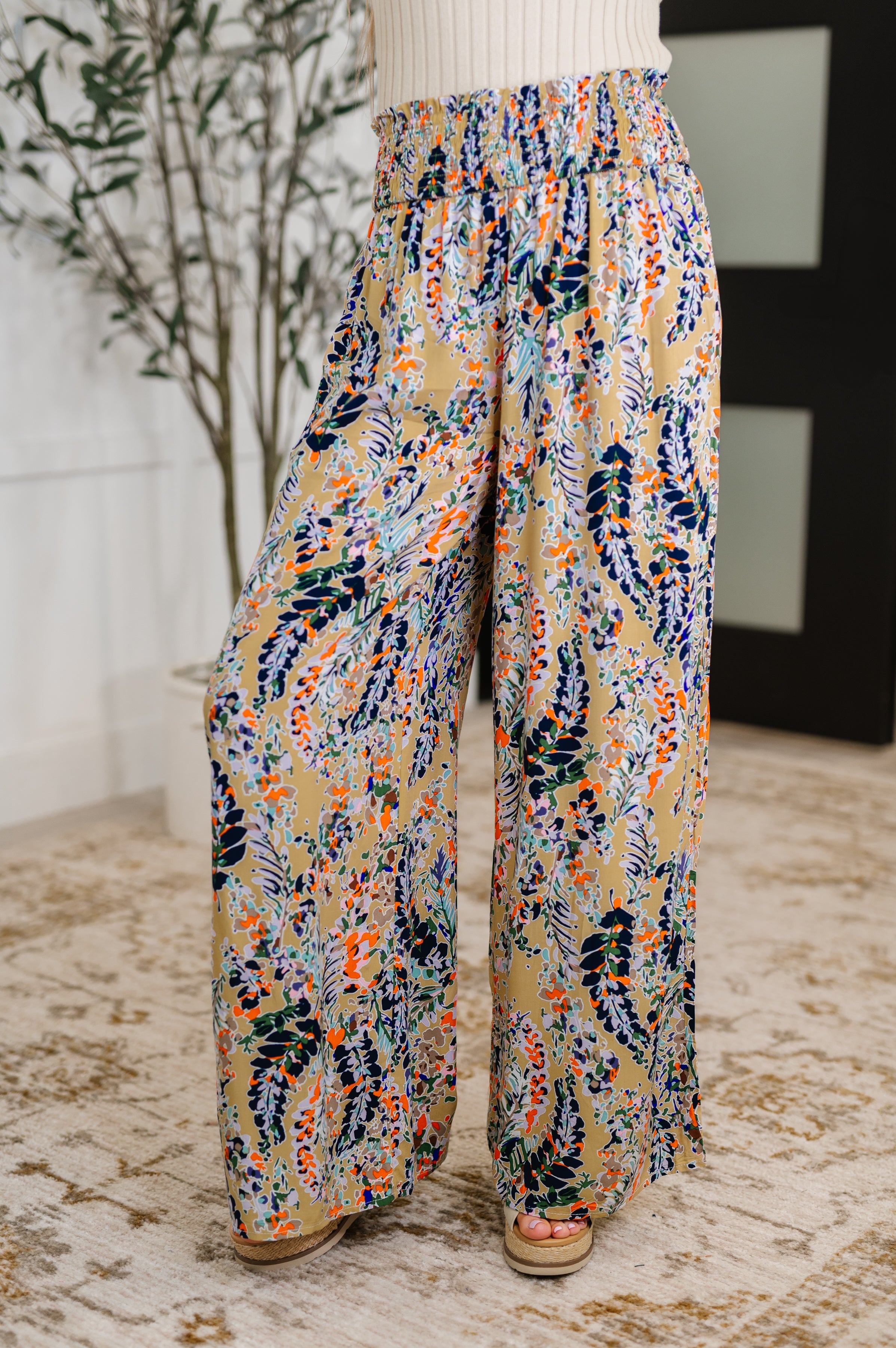 Colorful patterned pants worn by a person indoors.