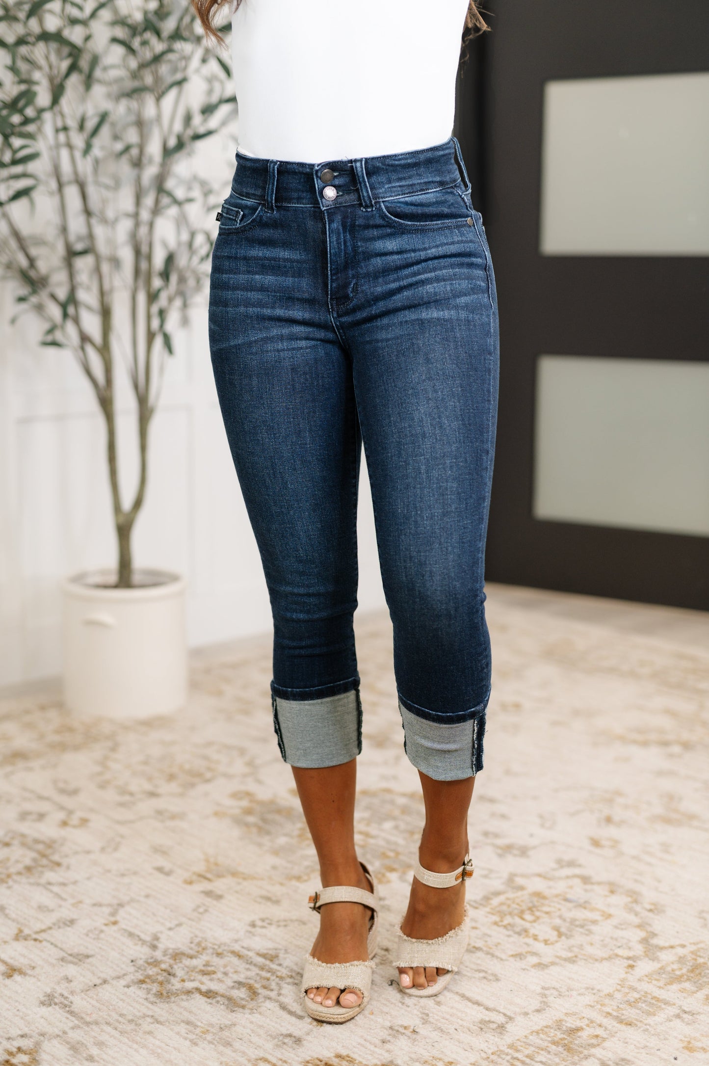 Woman wearing blue jeans with a white background