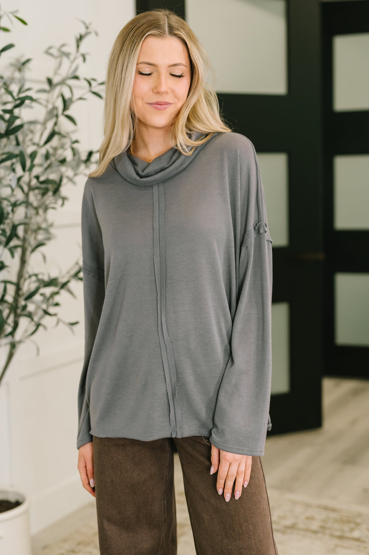 Gray turtleneck with center seam, drop shoulders, and relaxed fit.