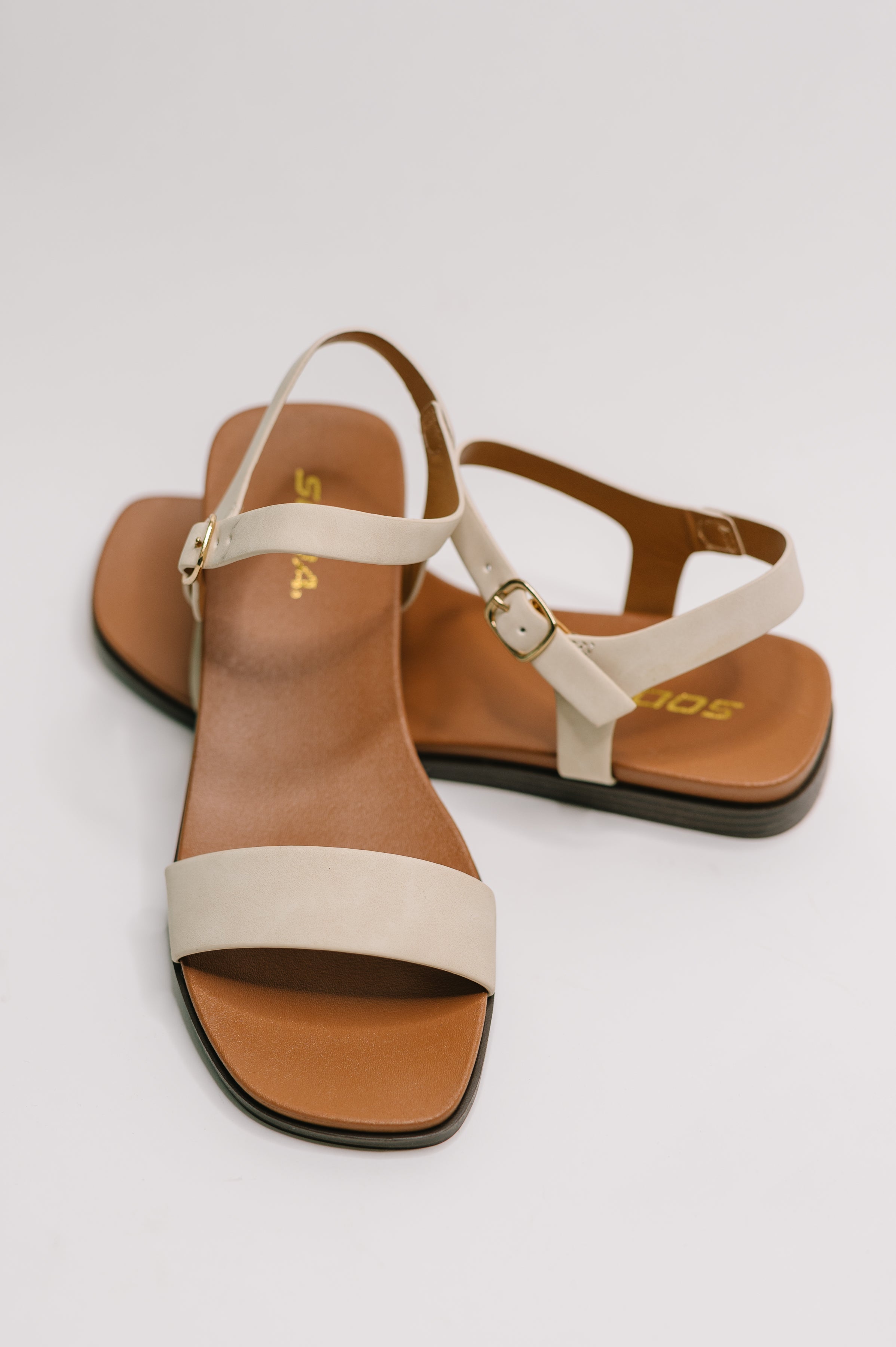 beige ankle strap sandals, square toe flat sandals, women's nubuck sandals, chic summer footwear, comfortable neutral flats, gold hardware sandals, Fabknits footwear