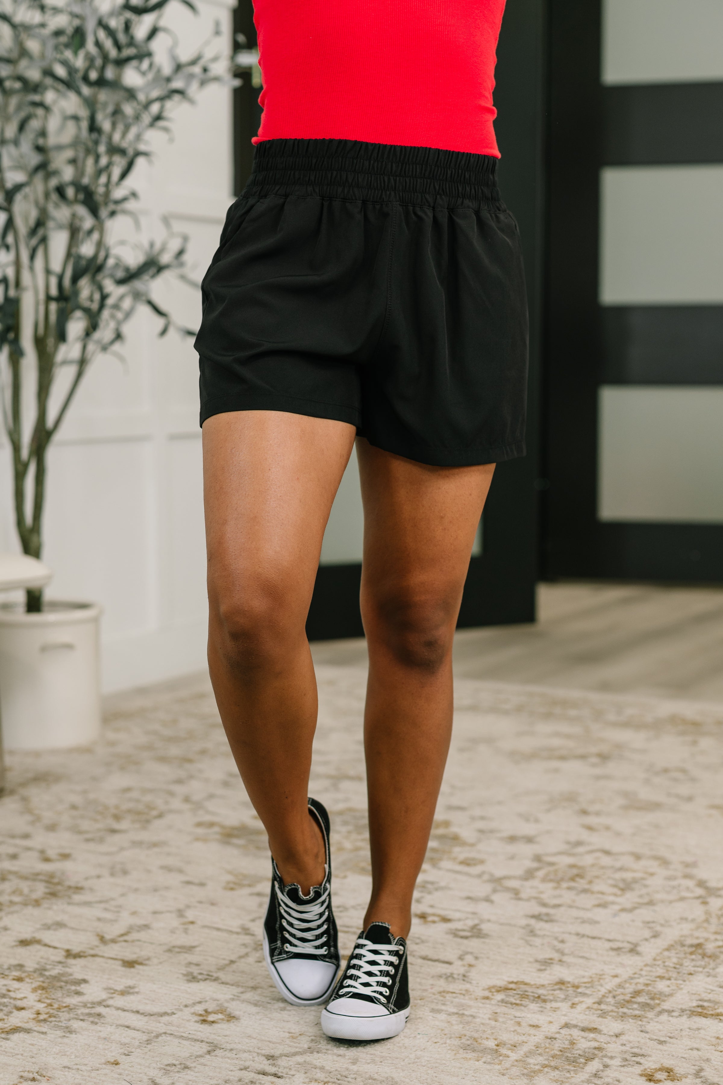 High waisted athletic shorts, black wide leg shorts, woven gym shorts, breathable activewear, women's workout shorts with pockets, structured athletic shorts, black athleisure shorts.