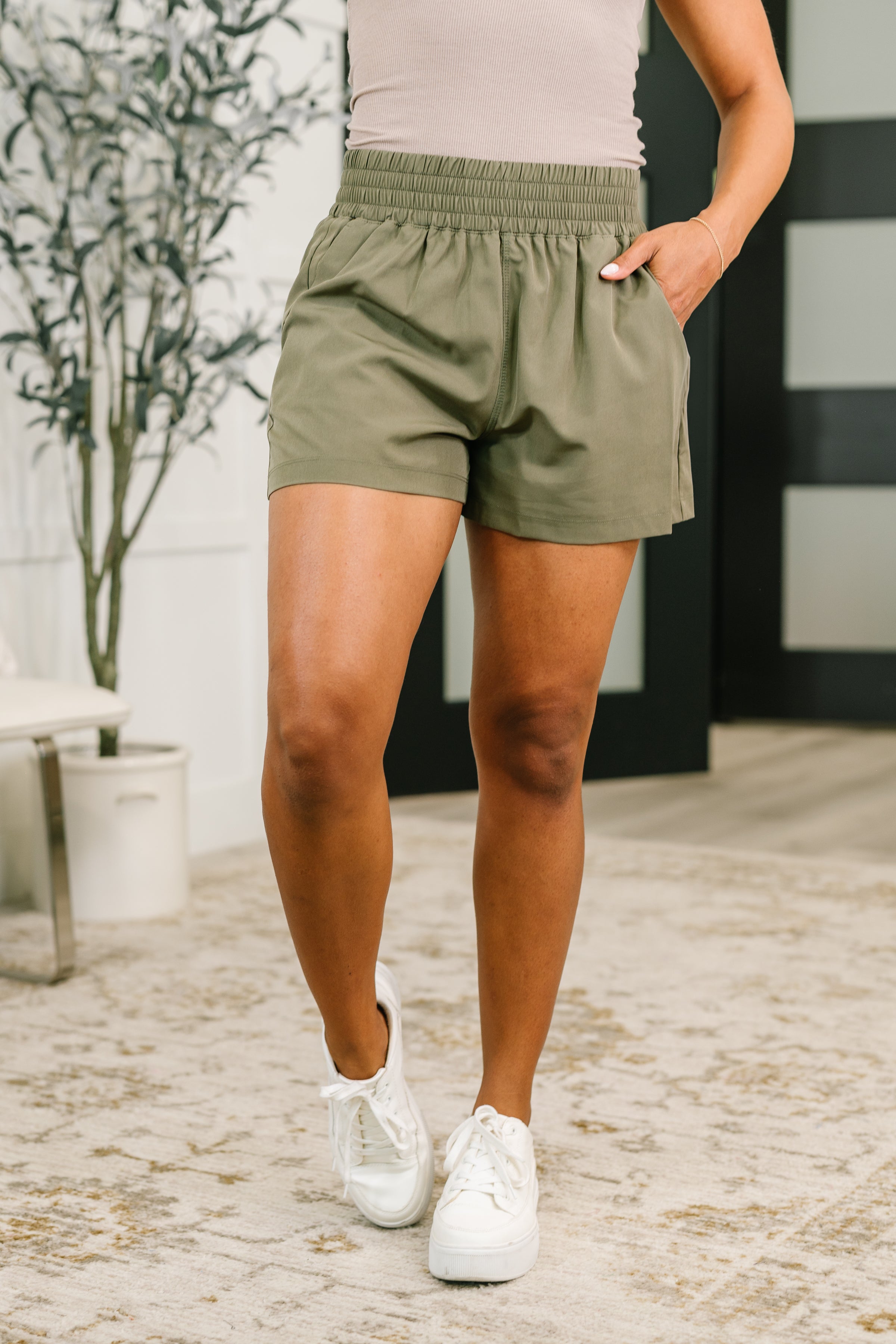 High waisted athletic shorts, dusty olive shorts, women's woven workout shorts, wide leg gym shorts, breathable activewear with pockets, structured athletic shorts.