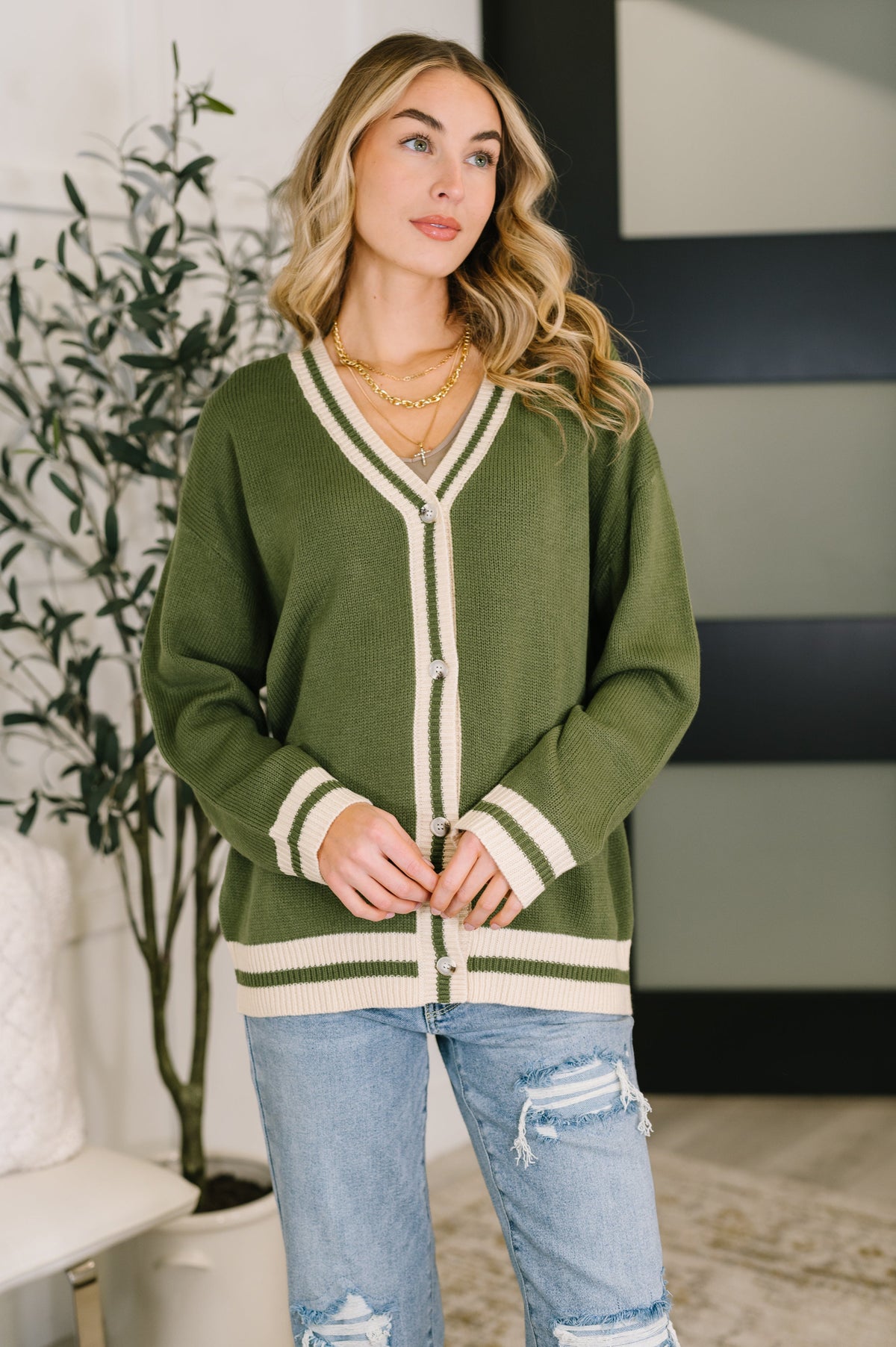 Green button-down cardigan with a ribbed deep V-neck and relaxed fit.