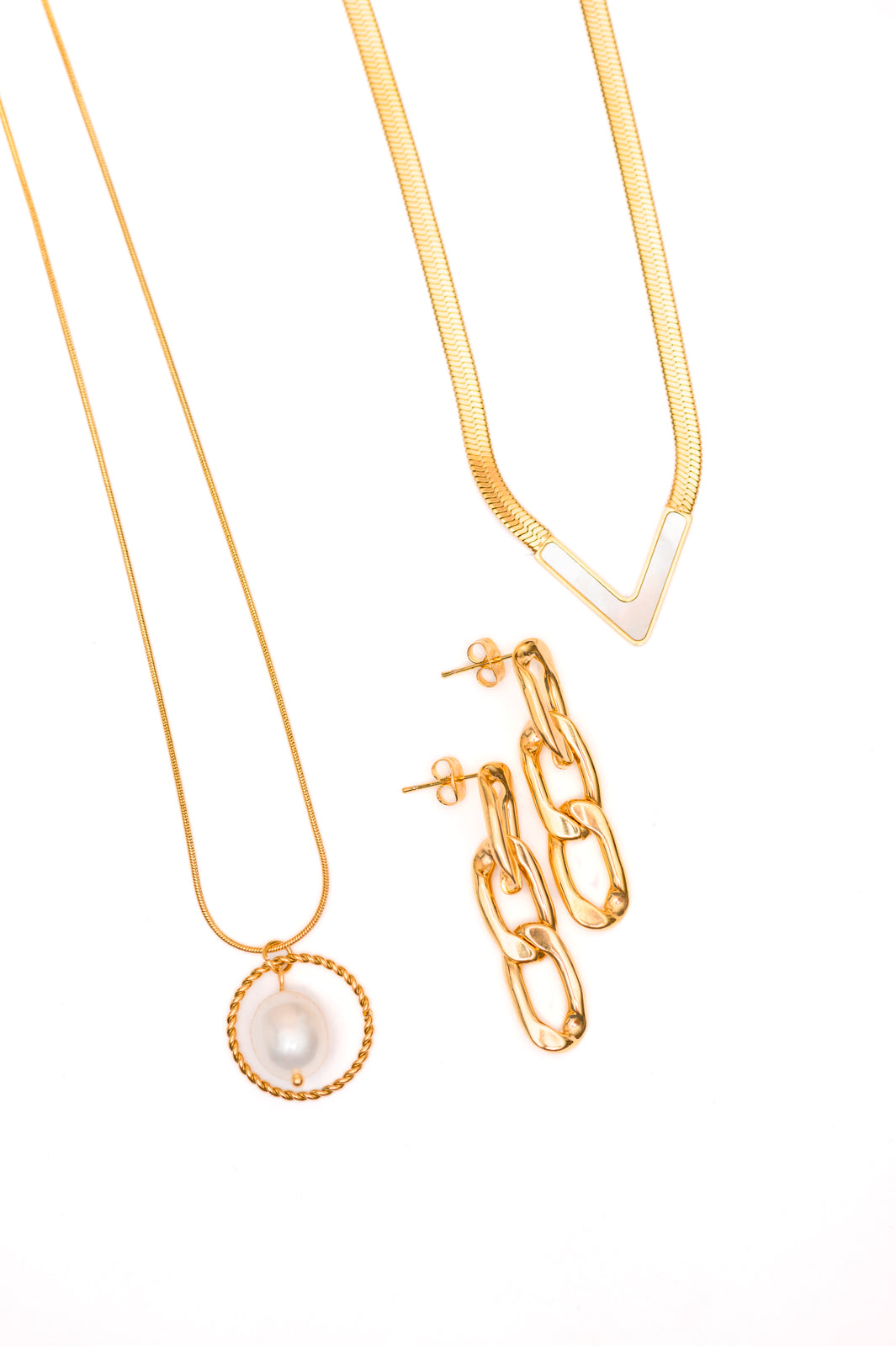 A gold-plated stainless steel pearl pendant necklace, a gold-plated stainless steel pearl v-necklace, and gold-plated stainless steel paper clip earrings, displayed against a white background.