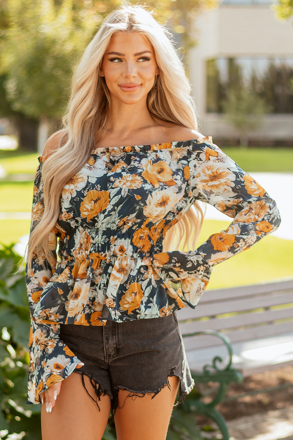 Luxury floral top, designer off-shoulder blouse, bell sleeve peplum, high-end bohemian fashion, smocked floral blouse, premium women's tops, boutique floral apparel.