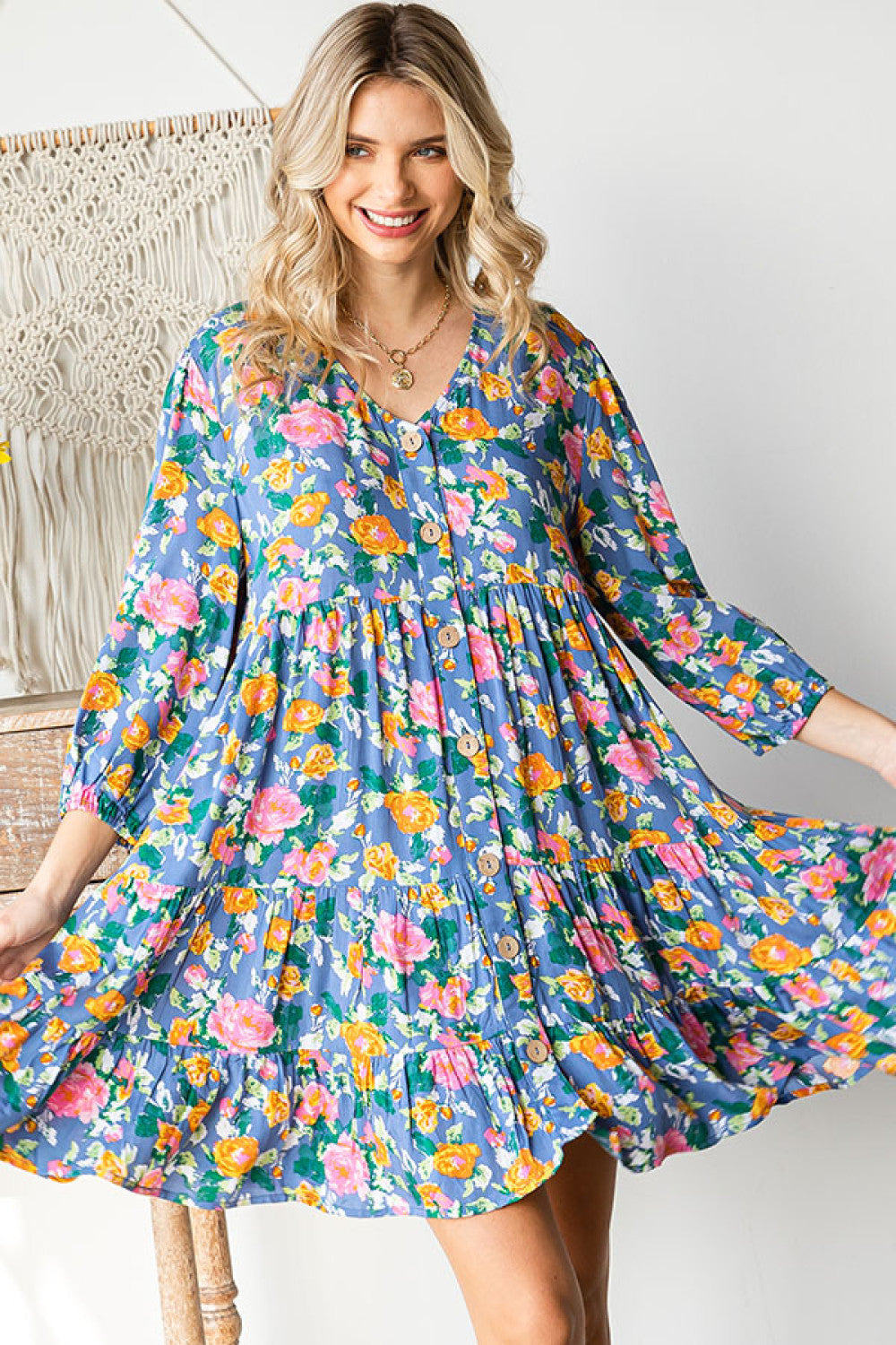 Woman wearing a colorful floral dress in a casual setting