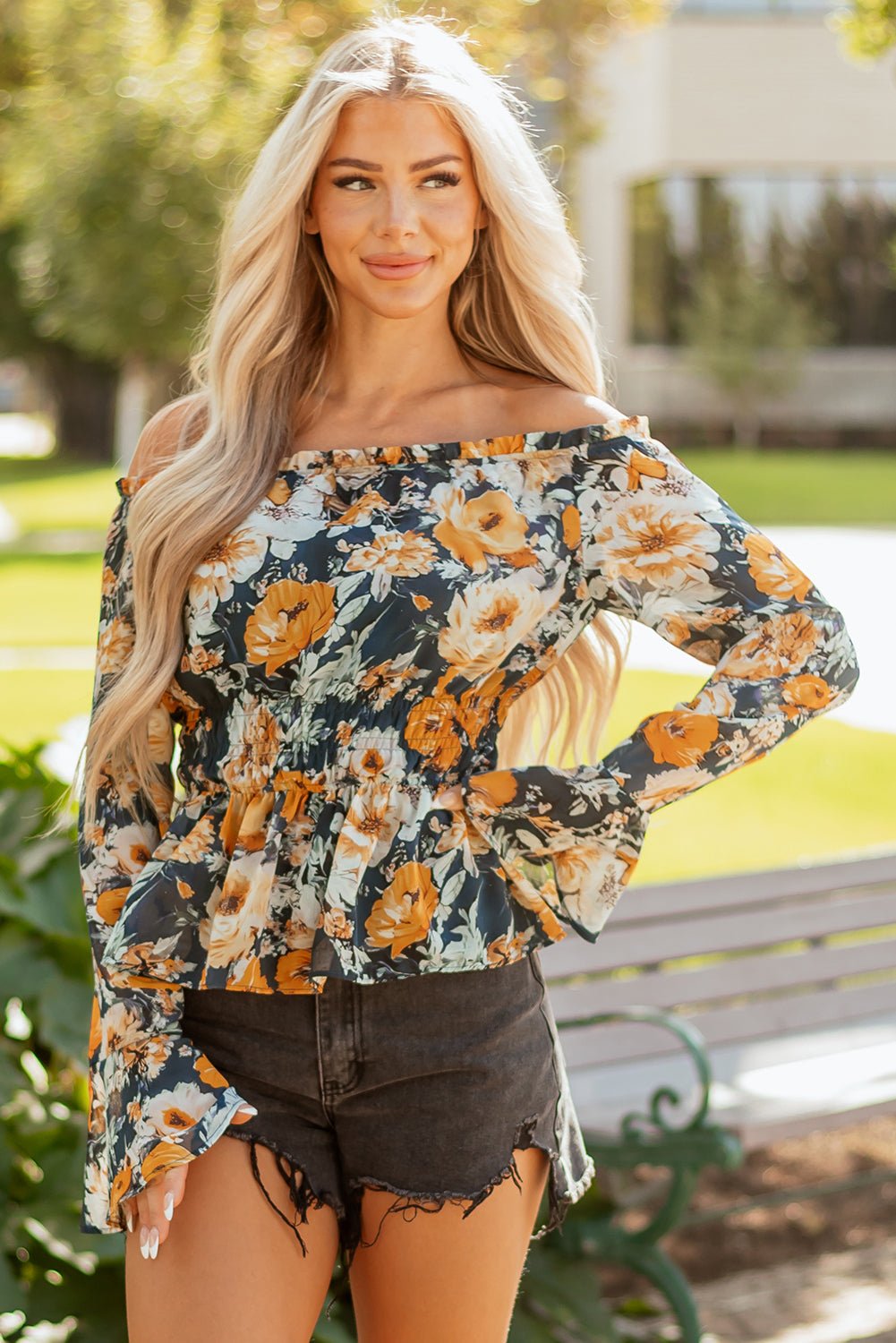Luxury floral top, designer off-shoulder blouse, bell sleeve peplum, high-end bohemian fashion, smocked floral blouse, premium women's tops, boutique floral apparel.