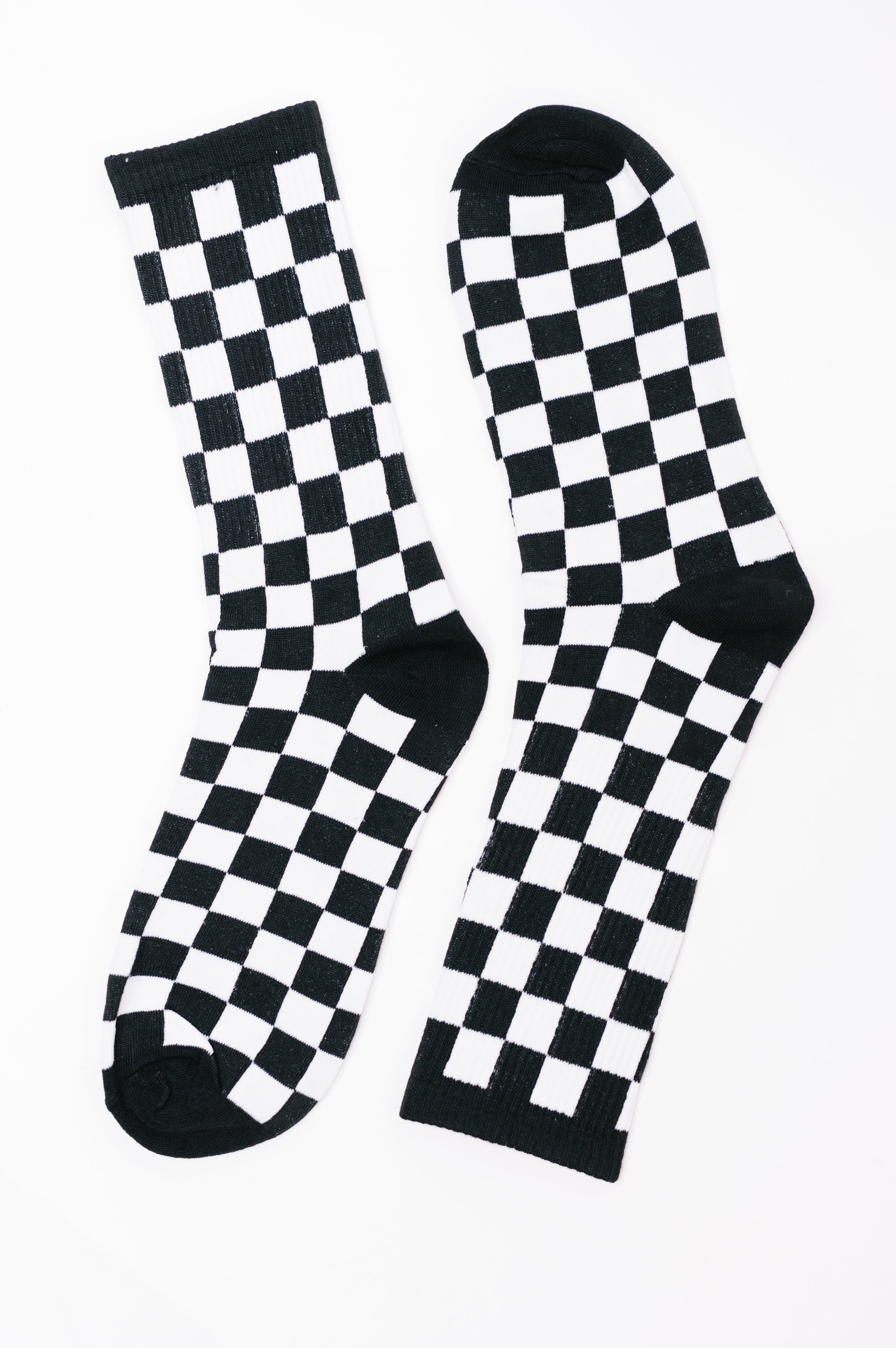Checkered socks, black and white socks, quarter length socks, streetwear accessories, high stretch knit socks, checkered pattern footwear, comfortable crew socks.