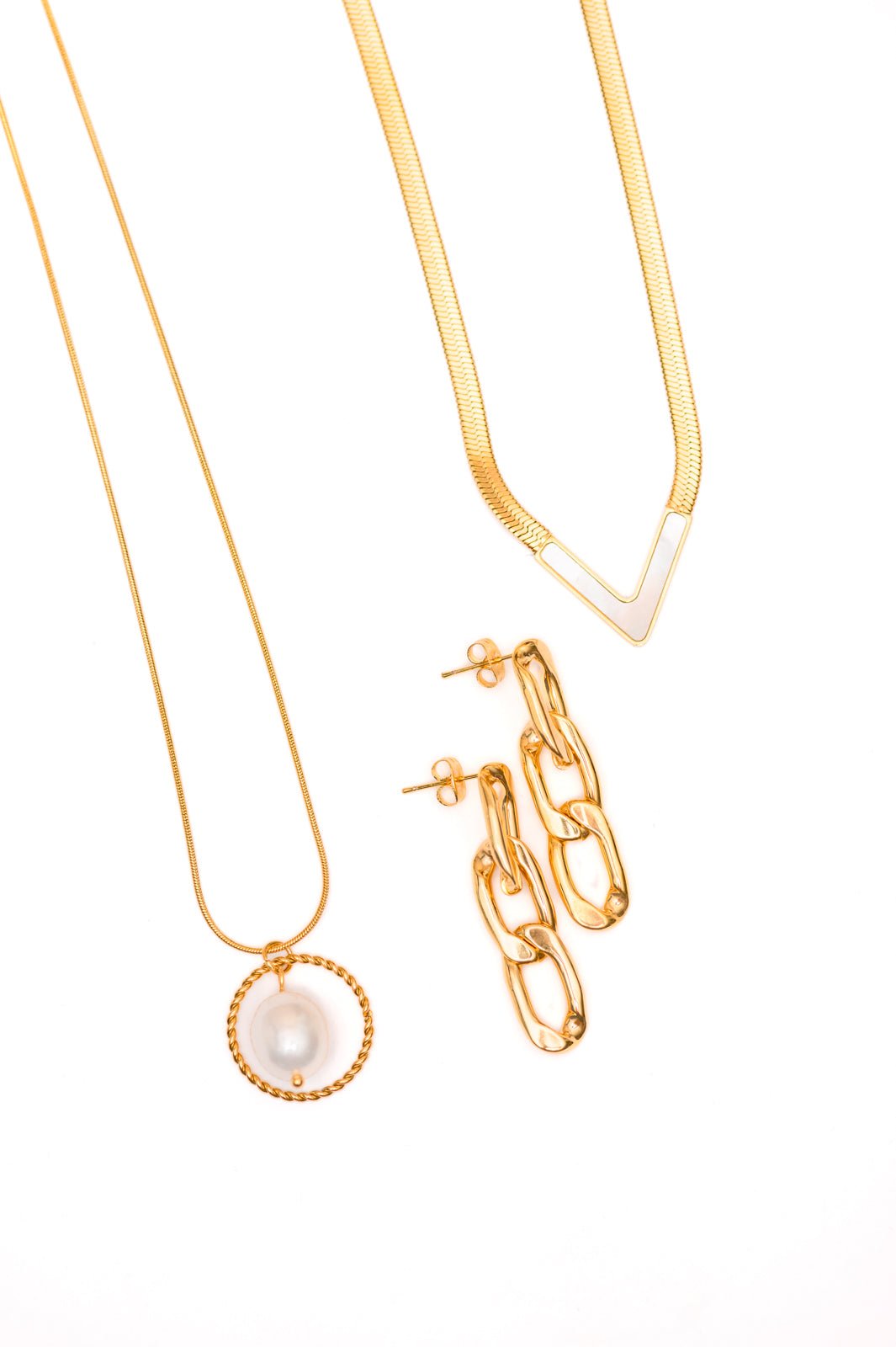 A gold-plated stainless steel pearl pendant necklace, a gold-plated stainless steel pearl v-necklace, and gold-plated stainless steel paper clip earrings, displayed against a white background.