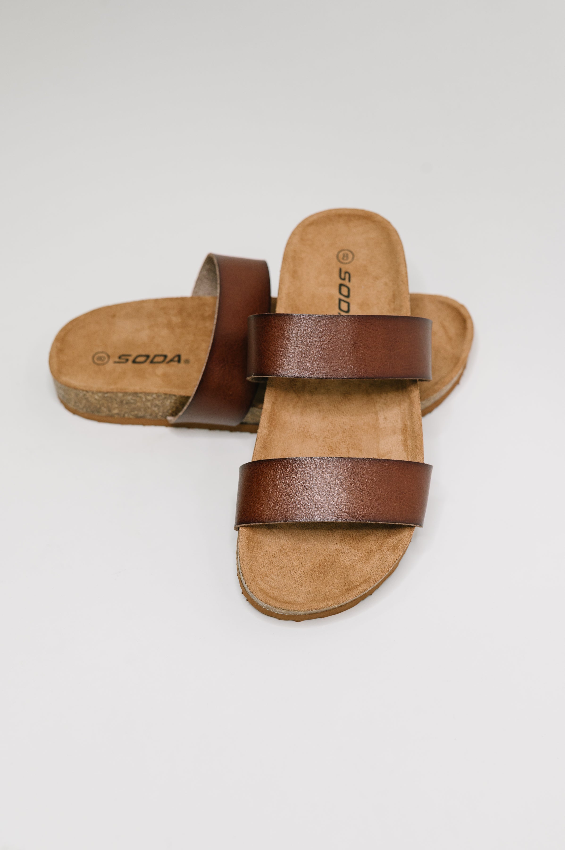 Light brown sandals, women's slip-on slides, two-strap comfort sandals, cork sole footwear, summer slides, PU leather sandals, everyday walking shoes, platform slide sandals.