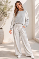 A grey lounge set with lace detailing, color block paneling, and an oversized fit.