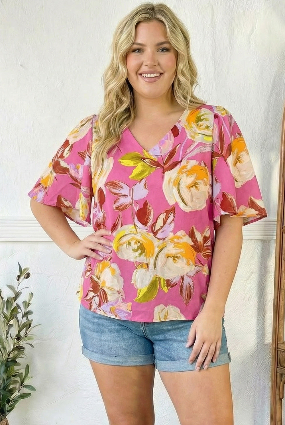 pink floral blouse, women's V-neck top, flutter sleeve blouse, summer floral top, painterly floral print, lightweight pink top, true to size blouse, women's boutique fashion, pink summer outfit, flattering women's tops.