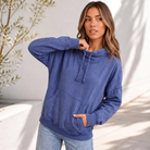 A relaxed oversized pullover in faded blue with a cowl neck and front kangaroo pocket.