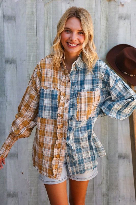 Woman wearing a plaid shirt and shorts standing against a wooden wall.