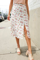 Woman wearing a floral skirt on a sidewalk