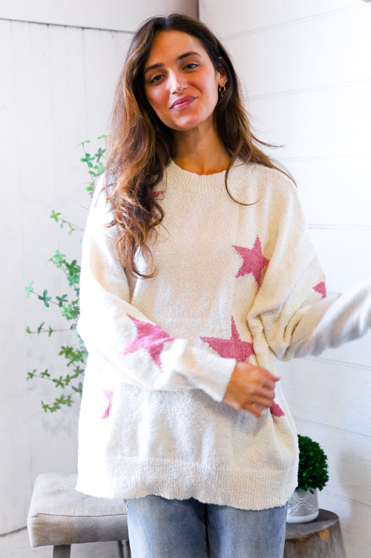 Woman wearing a white sweater with Pink Star Prints.