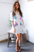 Woman wearing a striped dress with colorful roller skate designs indoors