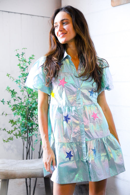 Woman wearing metallic mint dress with glittery stars.
