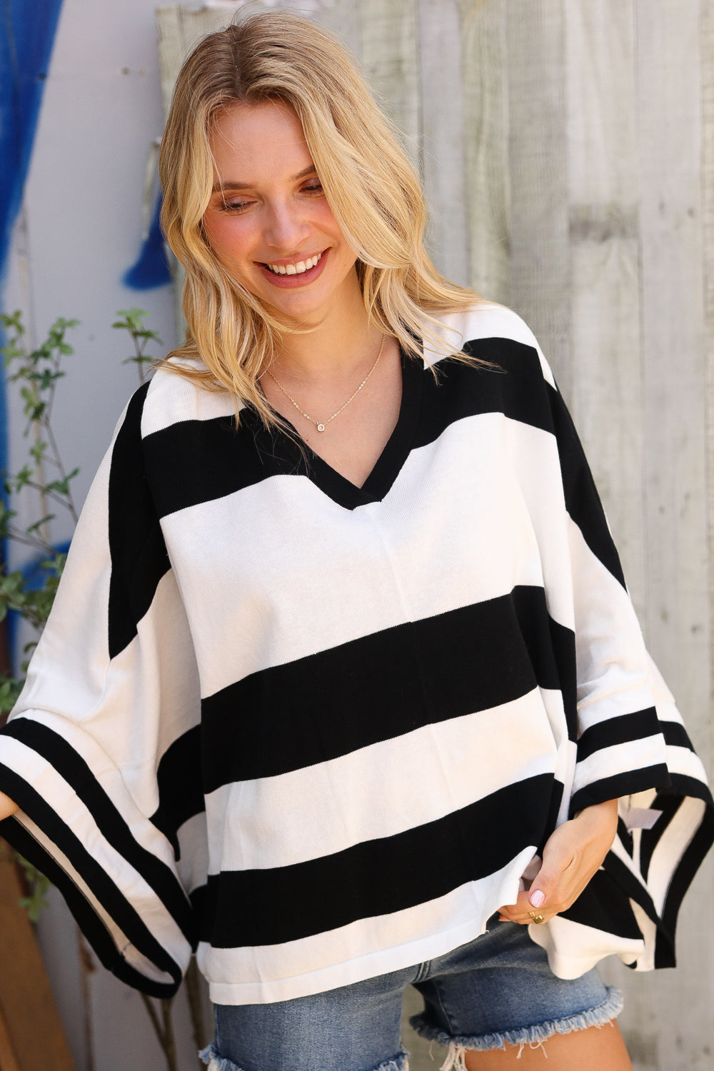 Woman wearing a black and white striped top with a blurred background