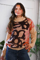 Woman wearing a floral patterned sweater with a neutral background