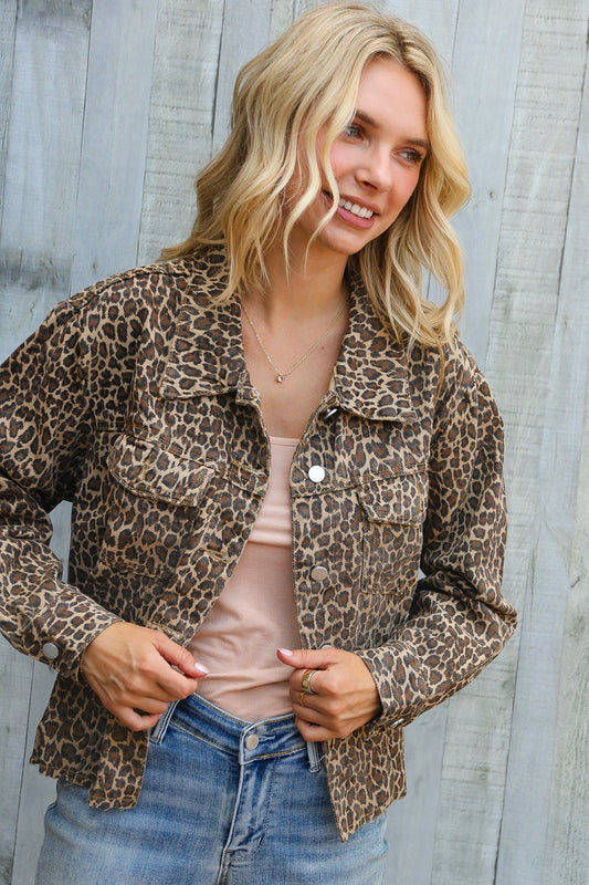 Woman wearing a leopard print jacket against a wooden background