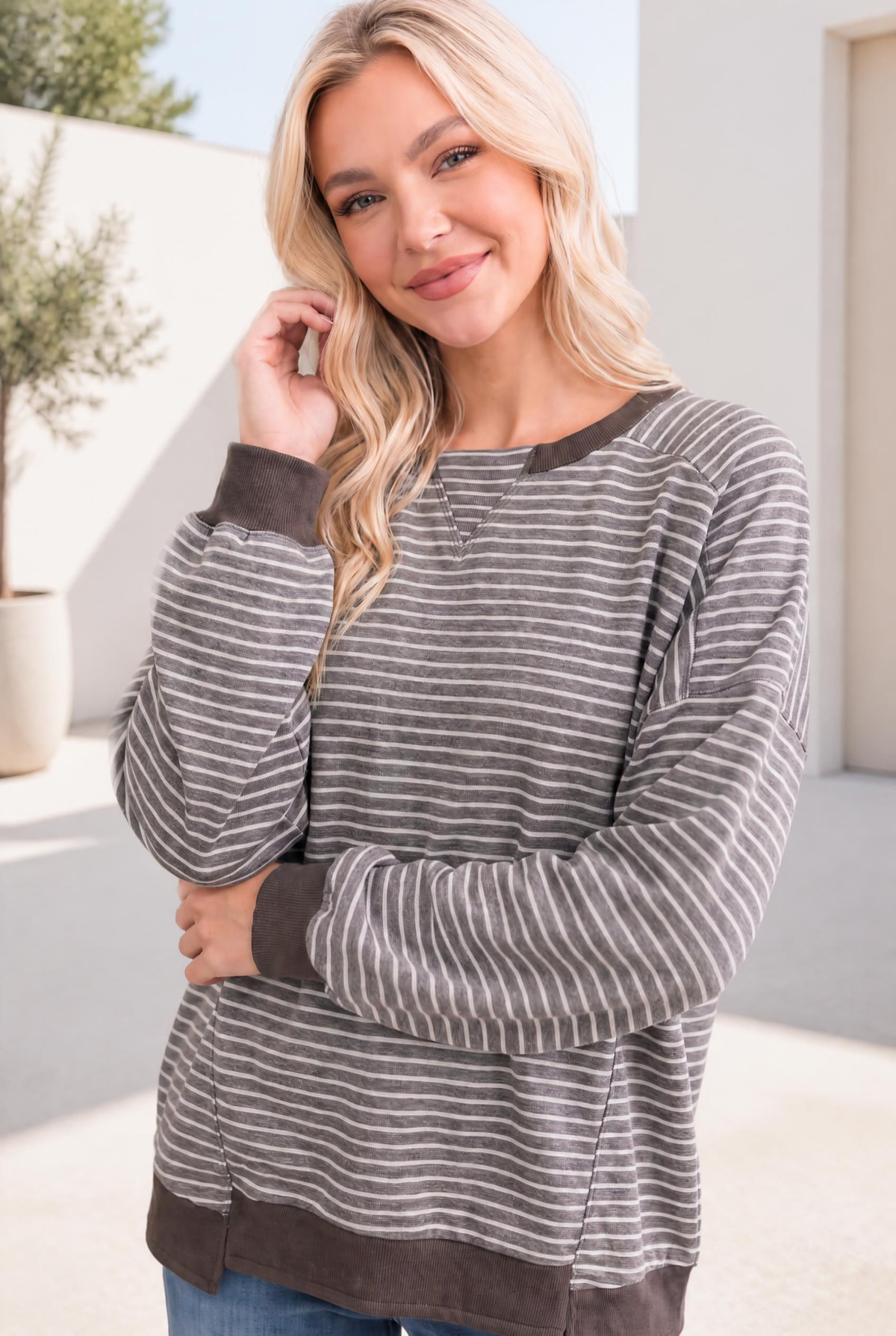 Relaxed raglan pullover with mocha and cream stripes, featuring ribbed cuffs and a casual fit.