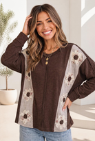 Chocolate brown long sleeve top with floral applique and gray side panels.