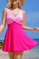 colorblock swimsuit, flared swimdress, one-piece swimwear, flattering swimsuit, V-neck swimdress, pink swimsuit, tummy control swimwear, beach fashion, supportive one-piece