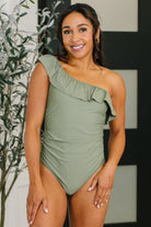one piece swimsuit, ruffled swimwear, asymmetrical swimsuit, slimming one piece, ruched bathing suit, boutique swimwear, women's designer swimsuit, sage green swimwear.
