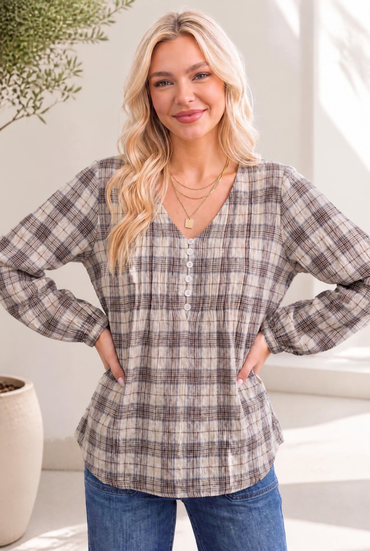 Plaid blouse with pintuck pleating, button front, blouson sleeves, and relaxed fit worn by a model.