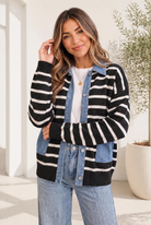 Woman wearing a black and cream striped knit jacket with denim panels, button front, and ribbed cuffs.