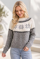 Model wearing a cream and grey colorblock pullover sweater with a Fair Isle snowflake yoke design.