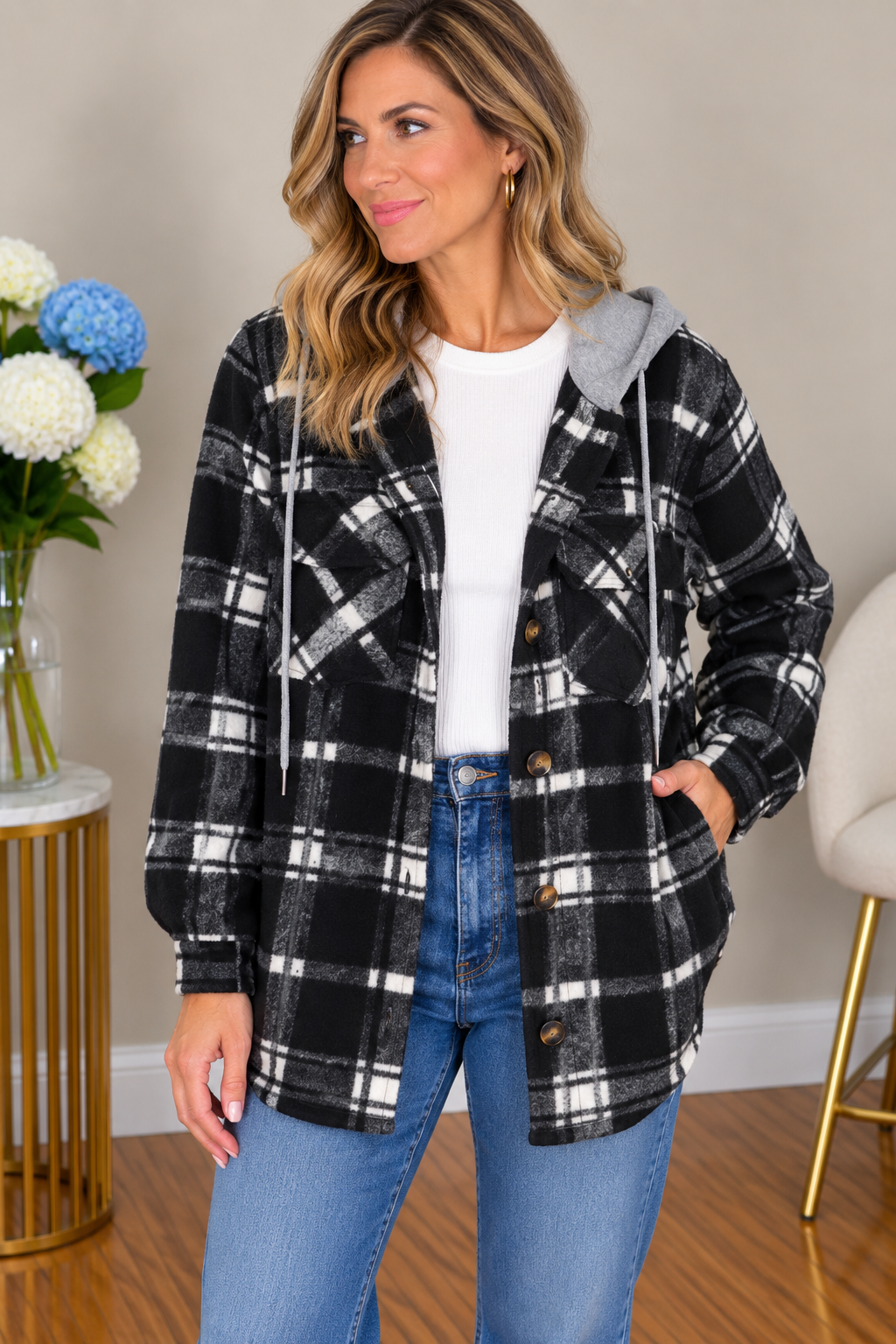 Woman wearing a plaid fleece jacket with long sleeves and button-down closure.