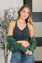 Charcoal bralette with a sweetheart neckline and cross strap back worn by a model.