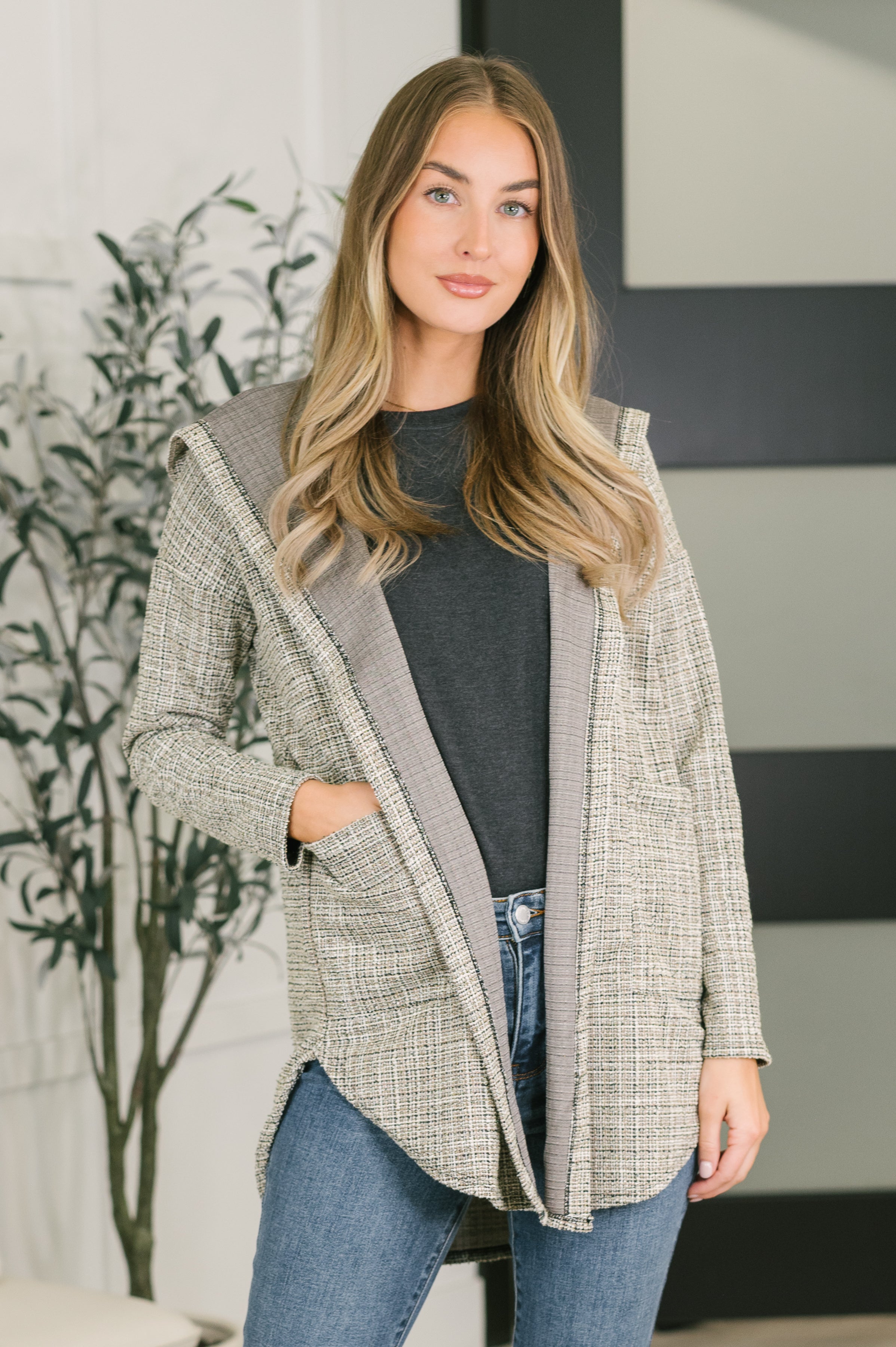 Neutral plaid hooded cardigan with open front, long sleeves, and patch pockets.