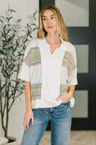 Collared knit top, textured V-neck shirt, women’s polo sweater, lightweight stretch knit, contrast detail blouse, modern casual knitwear, breathable spring top.