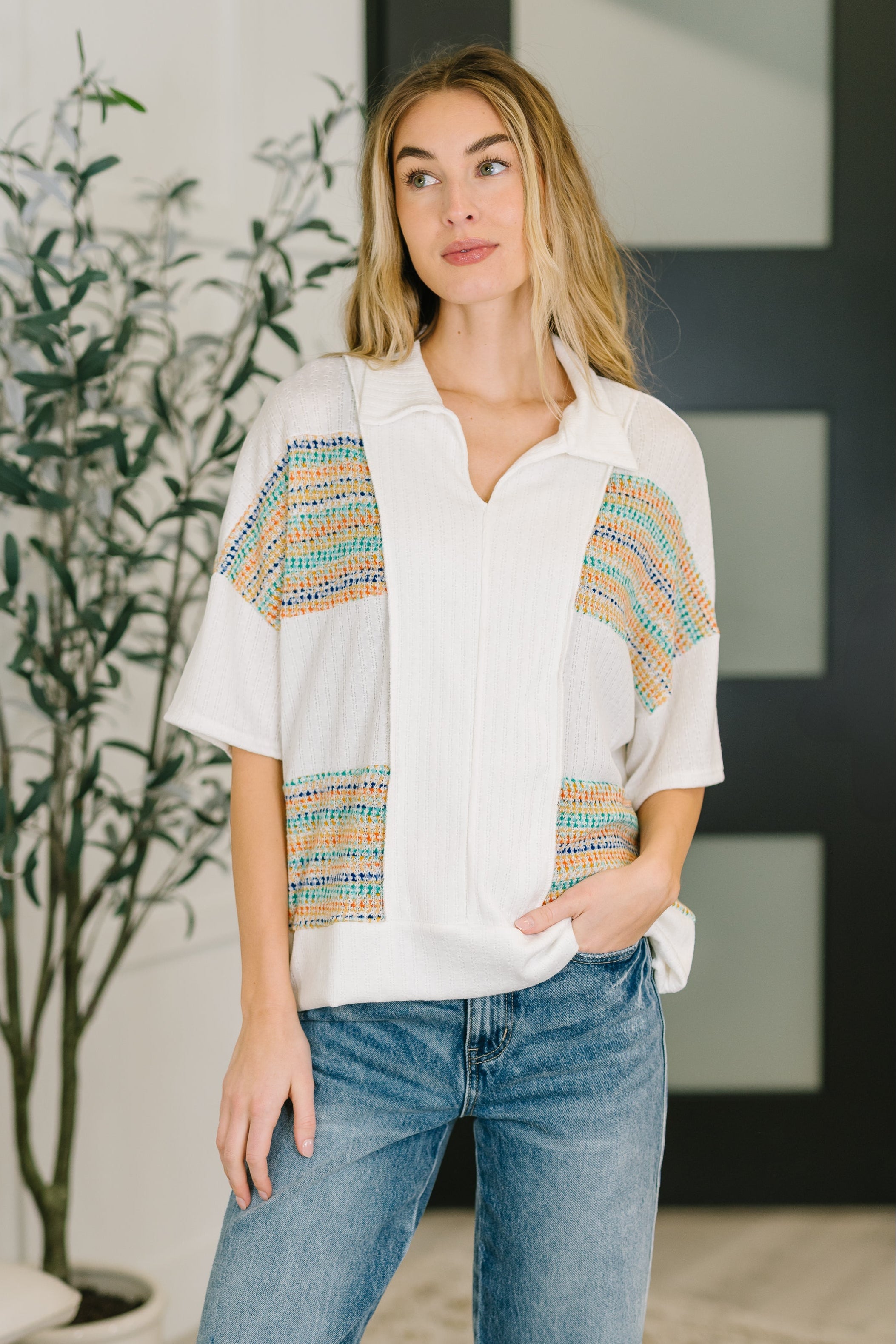 Collared knit top, textured V-neck shirt, women’s polo sweater, lightweight stretch knit, contrast detail blouse, modern casual knitwear, breathable spring top.