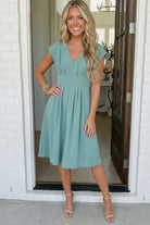 Sage green midi dress, pleated V-neck dress, wedding guest dress, empire waist midi, modest church dress, spring brunch outfit, A-line midi skirt, sage green cocktail dress.