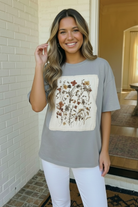 Wildflower graphic tee, oversized cotton shirt, vintage floral top, slate blue t-shirt, cottagecore aesthetic, garden inspired clothing, women's boho tee, breathable cotton top, artsy graphic shirt.