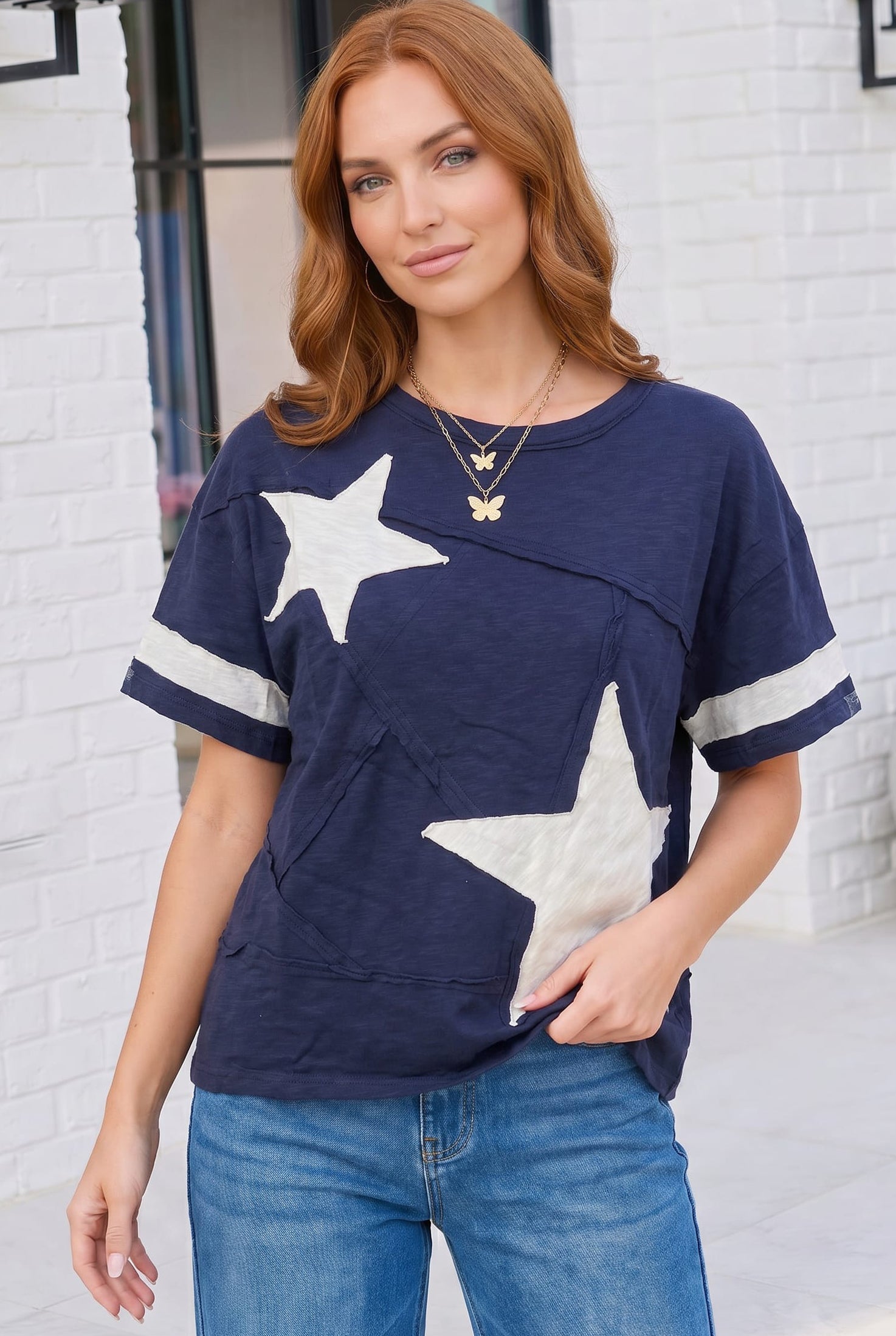 navy varsity tee, star applique shirt, cotton graphic tee, oversized navy top, sporty casual wear, women's varsity t-shirt, raw edge cotton tee, boho sporty style