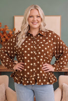 polka dot blouse, ruffle hem top, chocolate brown button down, oversized silky blouse, feminine work top, breezy fall fashion, women's polka dot shirt