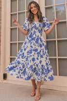Floral midi dress, smocked summer dress, blue floral sundress, tiered midi dress with pockets, flutter sleeve dress, casual summer fashion, brunch outfit ideas, 100% polyester dress.