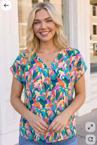 Tropical print top, multicolor V-neck blouse, abstract leaf print shirt, summer women's fashion, lightweight vacation wear, vibrant casual top, relaxed fit blouse.