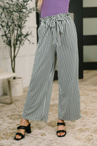 high waisted trousers, wide leg striped pants, jersey knit trousers, ruffle hem pants, comfortable work pants, women's elastic waist trousers, chic loungewear.