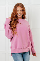 Pink fleece pullover with banded ribbed neckline and drop shoulders, worn by a model.